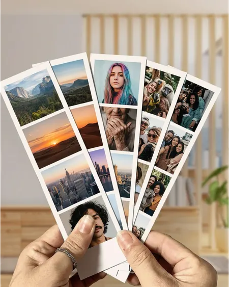Photo strips of landscapes and portraits fanned out in a hand